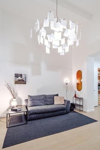 ein Wohnzimmer mit Sofa und Kronleuchter in der Unterkunft Loft35 - Vasca Idromassaggio - Nel cuore di Palermo - Self check-in in Palermo
