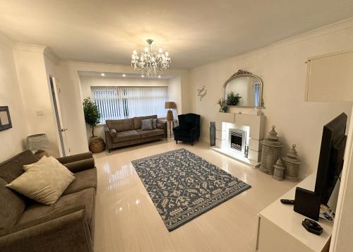 a living room with a couch and a fireplace at Comfy NEC, Birmingham Airport Stay, Free Parking in Birmingham