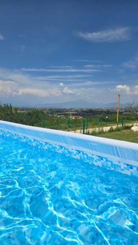 a large blue swimming pool with a view at Agricampeggio AL CIELO STELLATO in Valeggio sul Mincio