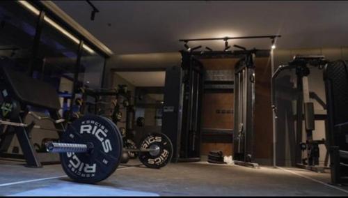 a room with a gym with a large dumbbell in it at Luxury apartment ALMajdiah Residence 3Q7 Boulevar البوليفارد in Riyadh