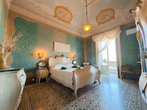 Postel nebo postele na pokoji v ubytování Palazzo Sabella Tommasi