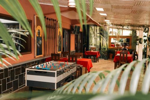 a room with a foosball table in a restaurant at 5 Swiss Hotel in Kigali