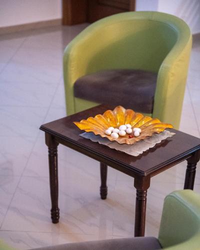 a table with a pumpkin on it with two chairs at Hotel Skrapari in Çorovodë
