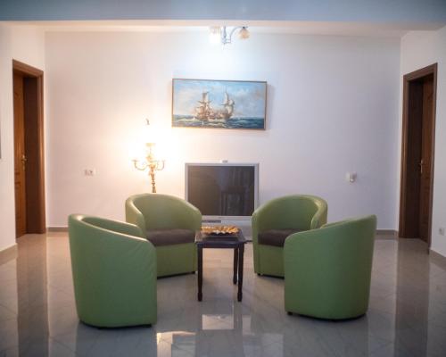 a living room with two chairs and a table at Hotel Skrapari in Çorovodë