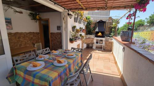 a table with plates of food on top of a house at Ático, terraza y Barbacoa in Barcelona