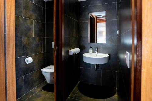 a bathroom with a sink and a toilet at Casa Rural Vistes de Morella in Morella
