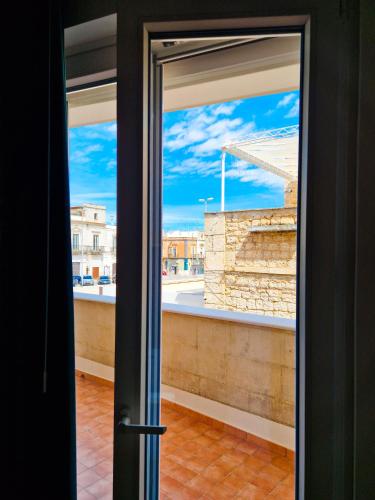 an open door with a view of a building at Dimora Odigitria in Bitritto