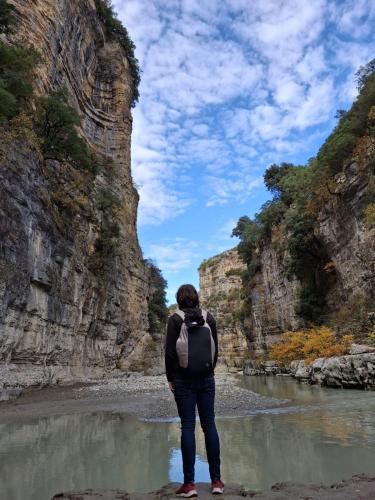 a person standing in the water in a river at Canyon's house in Çorovodë