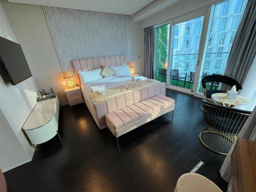 a bedroom with a bed and a large window at Ultra Luxury Palm Dubai Eye Fendi 2BR Damac Height in Sabkhah