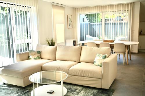 a living room with a couch and a table at Appartement de charme in Vaux-sur-Sûre