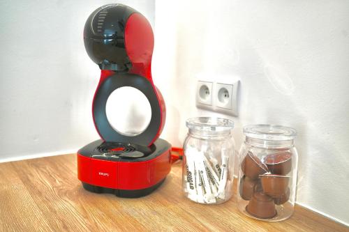 a red and black blender sitting on top of a table at Appartement de charme in Vaux-sur-Sûre