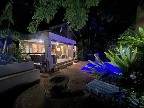 a backyard at night with blue lights at Pelican's Nest Holiday Home St Lucia in St Lucia