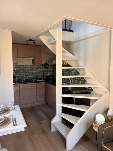 a staircase in a kitchen with a wine cellar at Beachhouse Noteboom, omheinde tuin in Noordwijk aan Zee