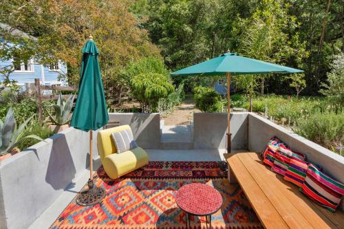 a patio with a table and an umbrella and a rug at Wine Country Retreat with Pool & Hot Tub - Dogs OK in Guerneville