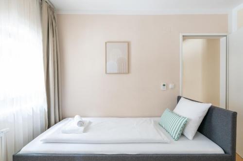 a bedroom with a bed and a mirror at Vienna Stay Apartments Schönbrunn in Vienna