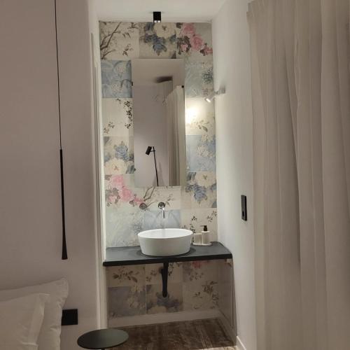 a bathroom with a sink and a mirror at Oro suites budget in Mikonos