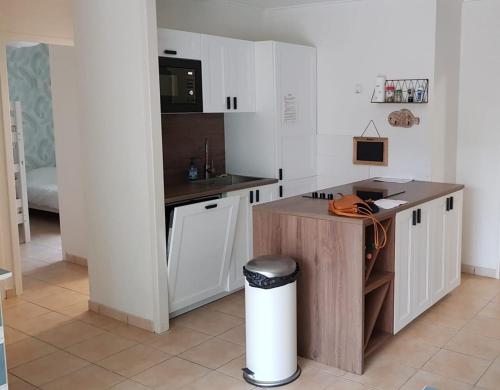 une cuisine avec des armoires blanches et un comptoir dans l'établissement Vacation home in a wooded park, à Saint-Jean-de-Monts