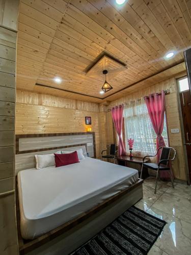 a bedroom with a large bed in a wooden room at Scenic Village Stay near Kufri With Bonfire & Veg Meals-Alpine Crest Homestay Kufri in Theog