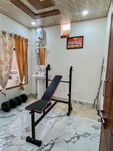 a gym with a bench in a room at Scenic Village Stay near Kufri With Bonfire & Veg Meals-Alpine Crest Homestay Kufri in Theog