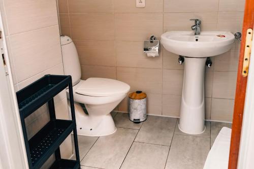 a bathroom with a toilet and a sink at 5 Swiss Hotel in Kigali
