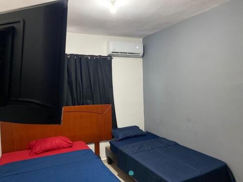 a room with two beds in a room with a window at Blue Beach 2 min to Miramar Beach in Ciudad Madero
