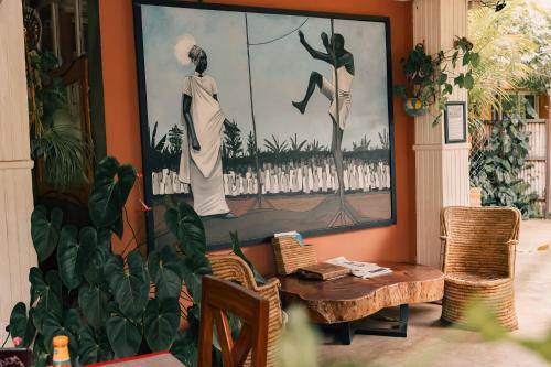 a room with a table and a painting on the wall at 5 Swiss Hotel in Kigali