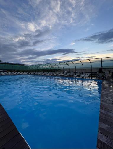 a swimming pool with blue water in front of a building at Boat Station in Kapchagay