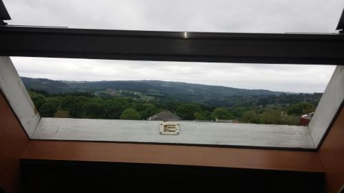 a view from a window of a mountain at Hotel Los Olmos in Lugo