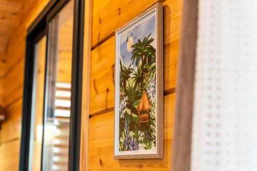 a picture on the side of a wooden wall at Jardin des Vieilles Pierres in La Plaine des Palmistes