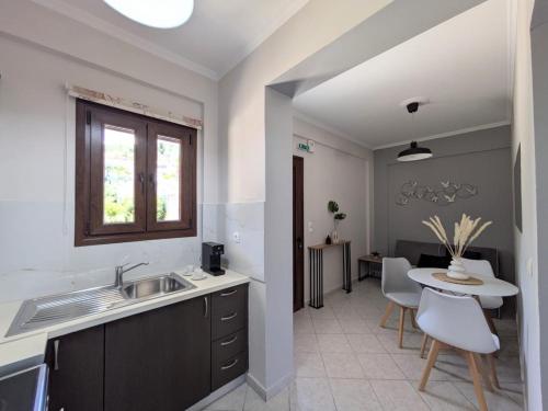 a kitchen with a sink and a table at Casa Marina in Syvota