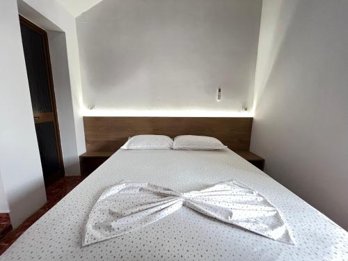 a bedroom with a bed with a bow on it at Villa Kasa in Durrës