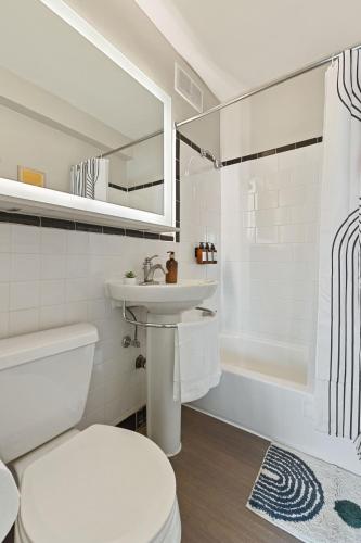 a white bathroom with a sink and a toilet at Free Parking - 1BR Arlington Stay Near DC in Arlington