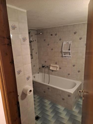 a bathroom with a tub and a toilet paper roll at P.A.G Apartments in Nea Roda