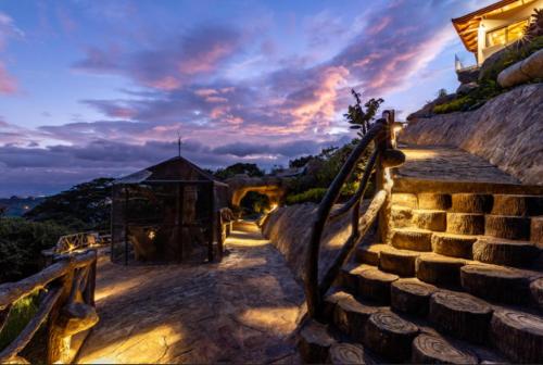 a set of stairs with a sunset in the background at Casa de Lujo con Piscina y Vistas Panorámicas Oro Monte, Naranjo in Naranjo
