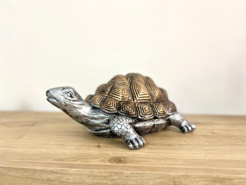 a small figurine of a turtle sitting on a table at La Casa di Nina in Castelnuovo Cilento