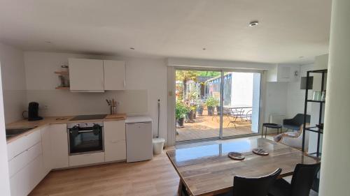 - une cuisine et une salle à manger avec une table et une vue dans l'établissement Bololo House, à Leffrinckoucke