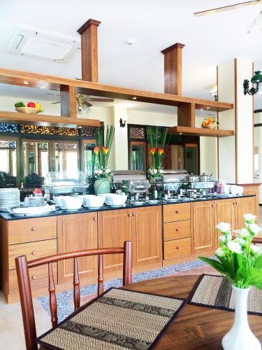 a large kitchen with a counter with pots and pans at i Boutique Hotel in Pluak Daeng