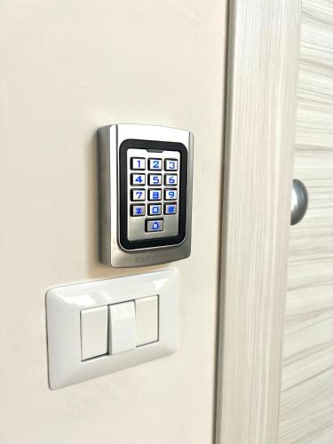 a door lock with a calculator on it at La Casa di Nina in Castelnuovo Cilento