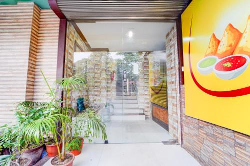 an entrance to a fast food restaurant with plants at Hotel O DH Road Ernakulam in Cochin