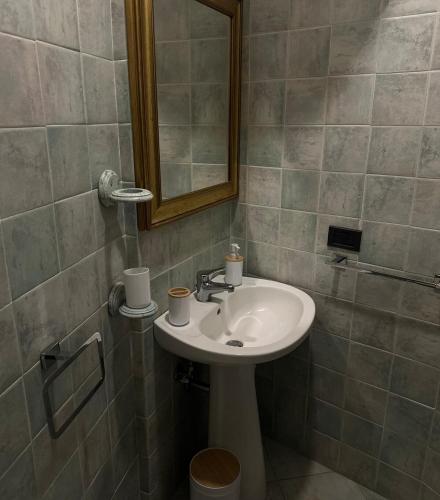 a bathroom with a sink and a mirror at Il Nido nel Cimino in Soriano nel Cimino