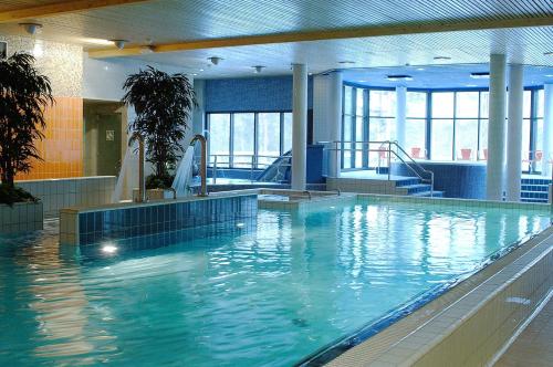 a large swimming pool with water in a building at Keurusselkä Resort in Keuruu