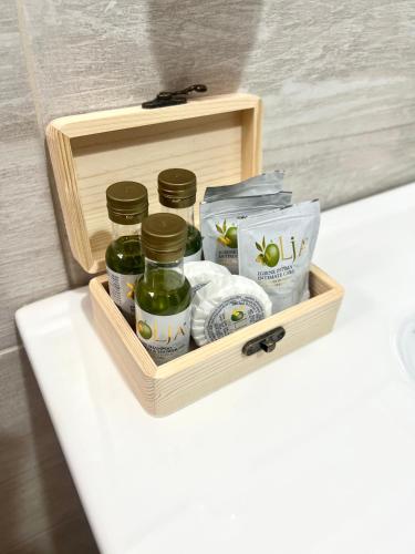 a wooden tray with jars of pickles on a table at La Casa di Nina in Castelnuovo Cilento