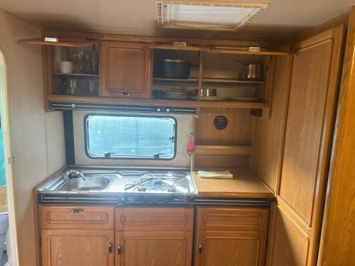 a kitchen with a stove and a sink in an rv at Romey Iikka in Pula