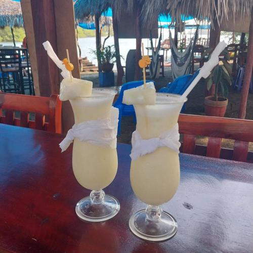 two cocktails sitting on top of a table at Mangrove Island Cabanas in Poneloya