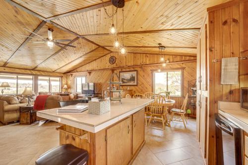 a kitchen and living room in a log cabin at Mtn and Golf Course Views Payson Retreat! in Payson