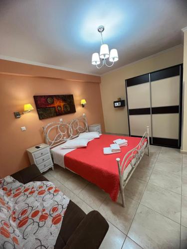 a bedroom with two beds and a red blanket at Casa Loutsiano in Syvota