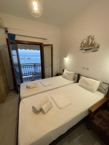 two beds in a room with a view of the ocean at Delfinia Studios in Platanias