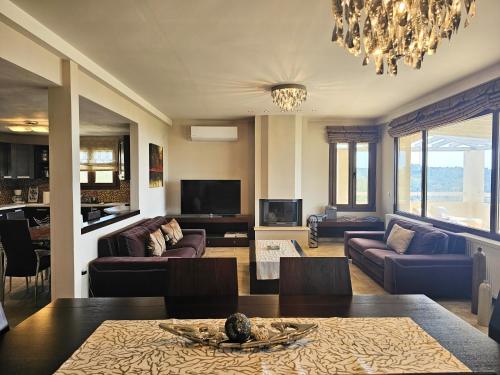 a living room with a couch and a table at Villa Theadora in Skiathos