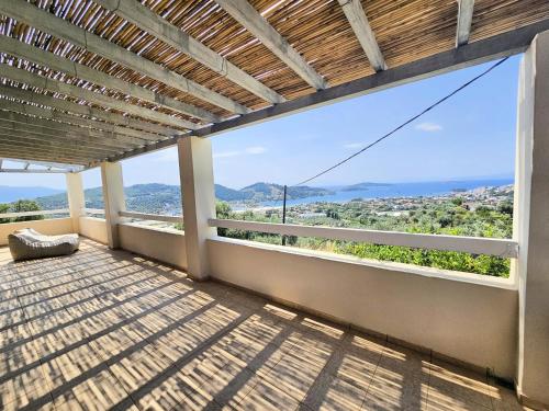 a balcony with a view of the mountains at Villa Theadora in Skiathos