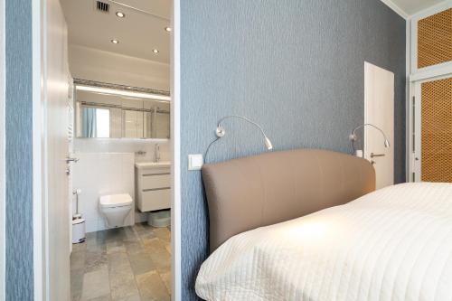 a bedroom with a bed and a bathroom at Panoramic App C09-8 in Sierksdorf